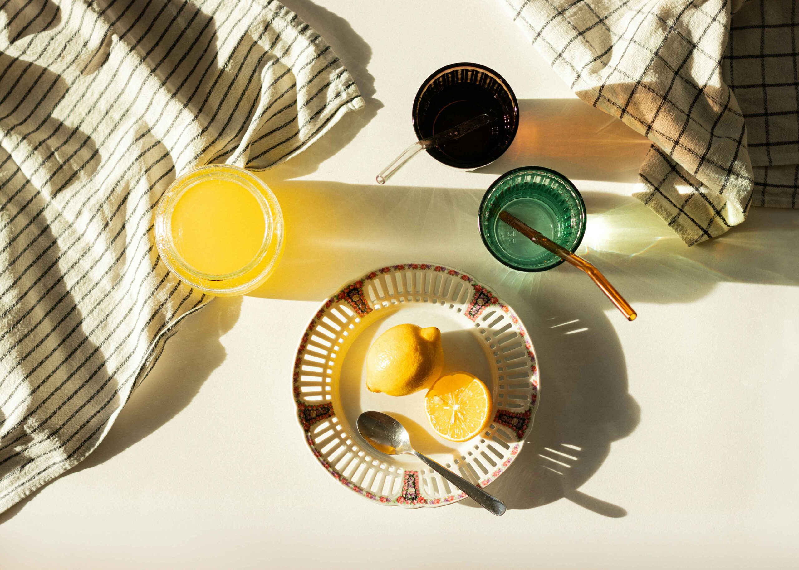 a plate of lemons and a spoon on a table